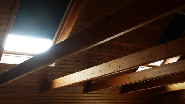 Dachboden mit offenen Holzbalken – die Dämmung der obersten Geschossdecke gehört zu den Nachrüstpflichten nach dem GEG